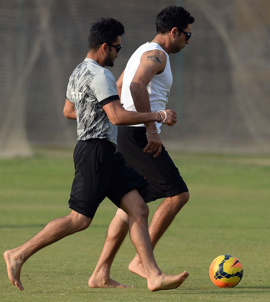 Happy feet: Virat Kohli and Yuvraj Singh during their football training