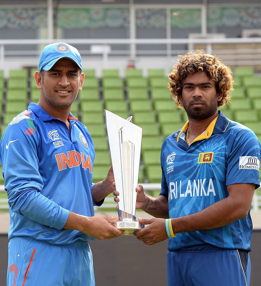 MS Dhoni and Lasith Malinga pose with the World Twenty20 trophy on the eve of the final