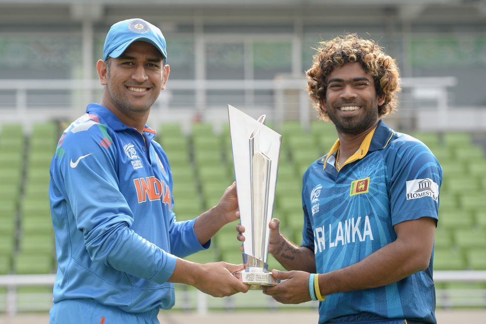 Sri Lanka captain Lasith Malinga and India captain Mahendra Singh Dhoni pose with the ICC World Twenty20 trophy ahead of the final.