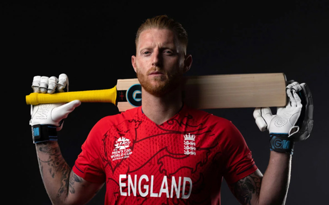 England 2022 T20I jersey in red with three lions and blue trousers, blending traditional and modern styles.