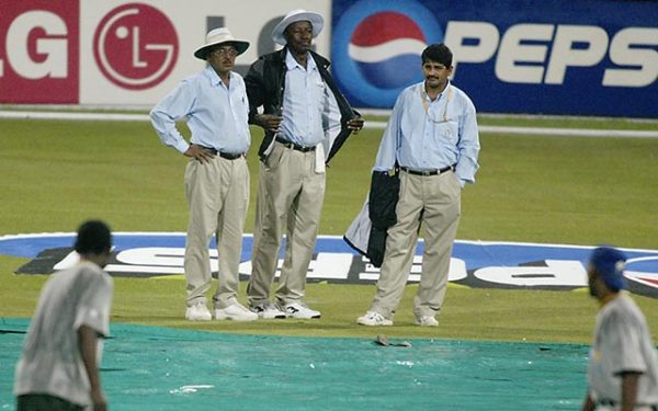 Umpires Venkat and Steve Bucknor carry out a pitch inspection after rain during the ICC Cricket World Cup 2003 Pool B match between South Africa and Sri Lanka