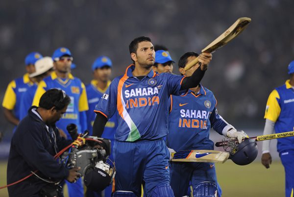 Indian cricketer Yuvraj Singh (C) raises his bat to mark India's victory of the second Twenty20 International match between India and Sri Lanka in Mohali on December 12, 2009. Sri Lanka won the first Twenty20 match in Nagpur on December 9 by 29 runs. AFP PHOTO/RAVEENDRAN (Photo credit should read RAVEENDRAN/AFP/Getty Images)
