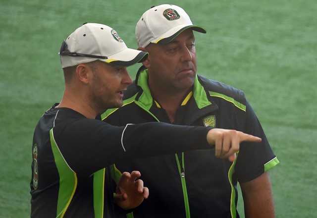 Australian captain Michael Clarke (L) speaks with coach Darren Lehmann during an indoor training session ahead of their 2015 Cricket World Cup match against Bangladesh at the Bupa National Cricket Centre in Brisbane on February 20, 2015. (Photo by INDRANIL MUKHERJEE/AFP/Getty Images)