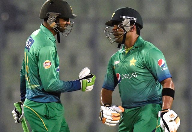 Shoaib Malik talks to his teammate Umar Akmal