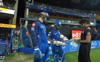Rohit Sharma's bat is being checked by umpire